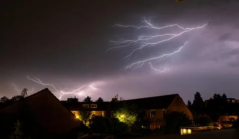 Dramatic spider lightning over residential neighborhood at night. Stock Photos