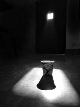 Dramatic Spotlight on Decorative Paper Cup in Dark Room Stock Photos