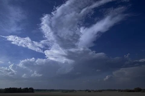 Dramatic Spring Cloudscape with Towering Cumulonimbus over Lithuanian Fields Stock-Fotos