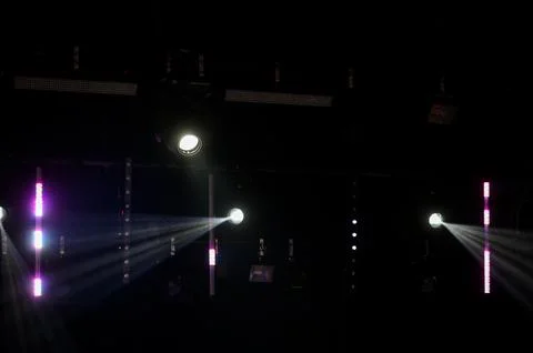 Dramatic Stage Spotlights with Light Beams in Dark Venue Stock Photos