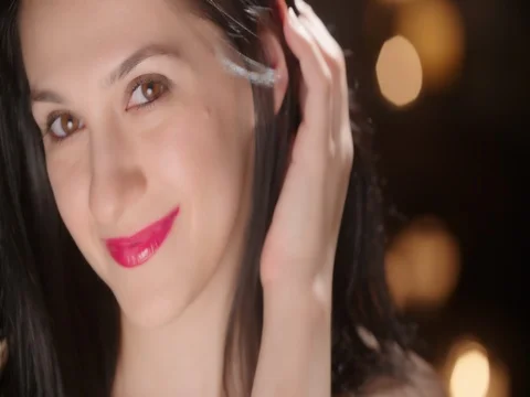 Dramatic Stare and Smile from Attractive Female with Bokeh Stock Footage 77841497