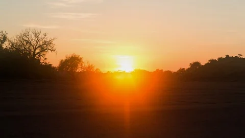 A dramatic static timelapse at sunrise of a dry riverbed with a moody orange sky Stock-Footage 143652629