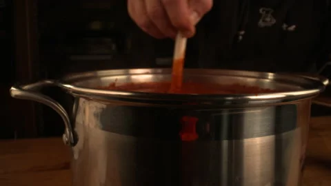 DRAMATIC STIRRING OF MARINARA SAUCE AS STEAM RISES OFF SPATULA Stock Footage 130407907