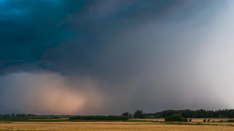 Dramatic Storm Cloud Base with Rain Shafts at Sunset Time-Lapse Stock Footage 327457202