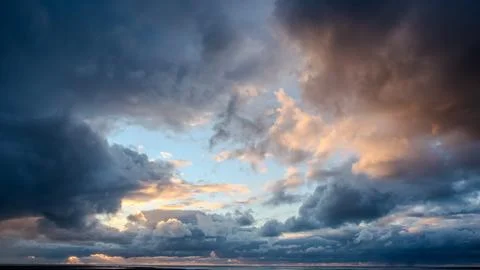 Dramatic Storm Clouds Above North Sea Coast at Sunset Stock Photos