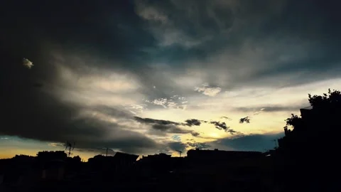 Dramatic Storm Clouds and Sun Rays Timelapse Over Urban Skyline in 4K Stock Footage 341668288
