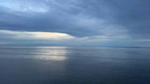 Dramatic Storm Clouds and Sunlight Reflection on Baltic Sea Stock Footage 343799838