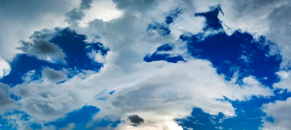 Dramatic storm clouds with blue sky in openings; Calgary, Alberta, Canada Stock Photos