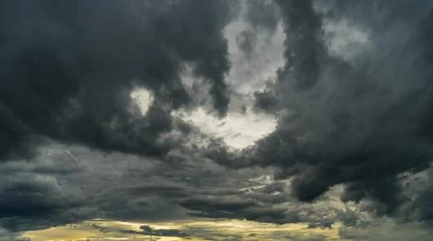Dramatic storm clouds at dark sky Stock Photos