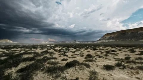 Dramatic storm clouds gather over arid landscape with sparse vegetation and Stock Footage 340516096