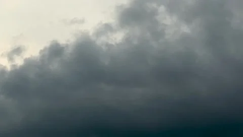 Dramatic storm clouds gathering in the sky with hints of sunlight peeking t.. Video stock 339369043