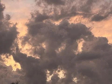 Dramatic Storm Clouds Glowing with Sunset Light Before Thunderstorm Stock Photos