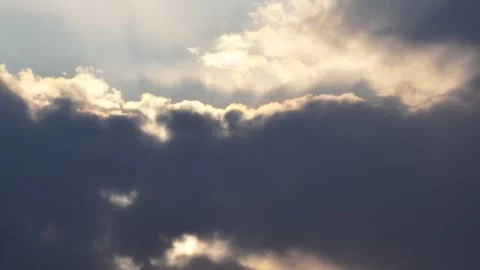 Dramatic storm clouds with golden sunlight breaking through at dusk Stock Footage 337788088