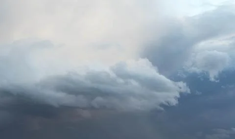 Dramatic storm clouds in gray and blue sky before rain Stock Photos