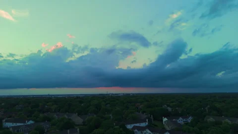 Dramatic storm clouds illuminated by the setting sun. Golden sunlight breaks Stock Footage 338319727