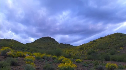 Dramatic storm clouds move over blooming mountain Stock Footage 73721873