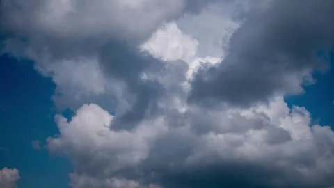 Dramatic Storm Clouds Moving Across Deep Blue Sky Stock Footage 318358796
