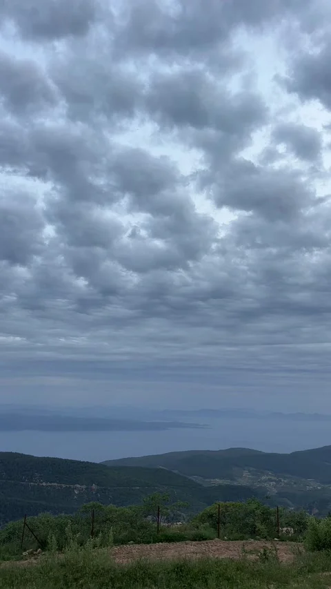 Dramatic Storm Clouds Over Aegean Sea and Mountain Landscape Stock Footage 335946220