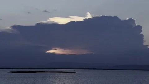Dramatic Storm Clouds Over a Calm Lake Stock Footage 341298235