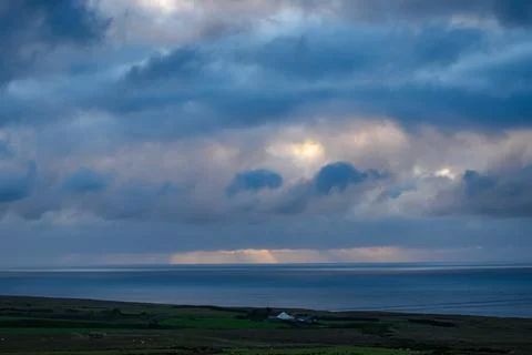 Dramatic storm clouds over coastal hills and ocean, dark sky and moody nature la Stock Photos