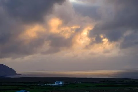 Dramatic storm clouds over coastal hills and ocean, dark sky and moody nature la Stock Photos