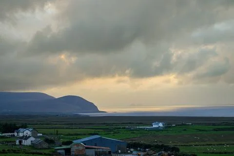 Dramatic storm clouds over coastal hills and ocean, dark sky and moody nature la Stock Photos