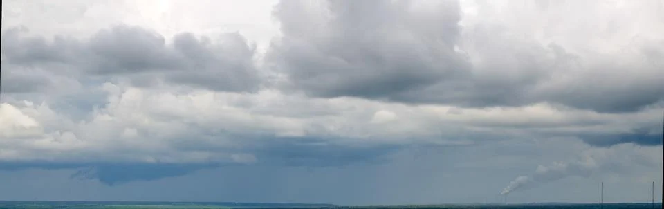 Dramatic storm clouds over distant landscape Foto stock