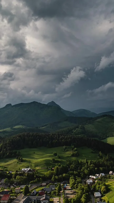 Dramatic Storm Clouds Over Green Countryside, Aerial Vertical Timelapse Stock Footage 311574180