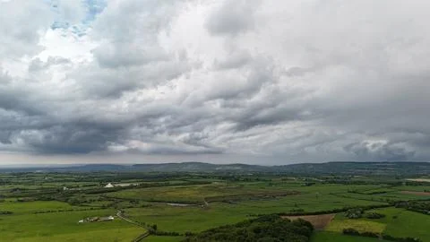 Dramatic Storm Clouds Over Green Rural Farmland 스톡 사진