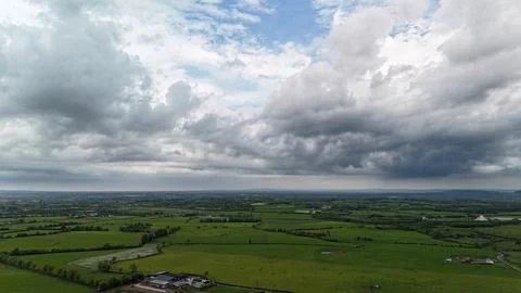 Dramatic Storm Clouds Over Green Rural Farmland 스톡 사진