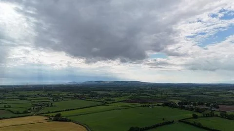 Dramatic Storm Clouds Over Green Rural Farmland 스톡 사진