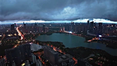 Dramatic Storm Clouds Over Modern Urban Skyline at Dusk Hefei Anhui China 動画素材 346927873