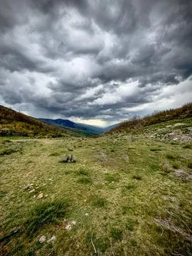 Dramatic Storm Clouds Over a Mountain Valley Stock Photos
