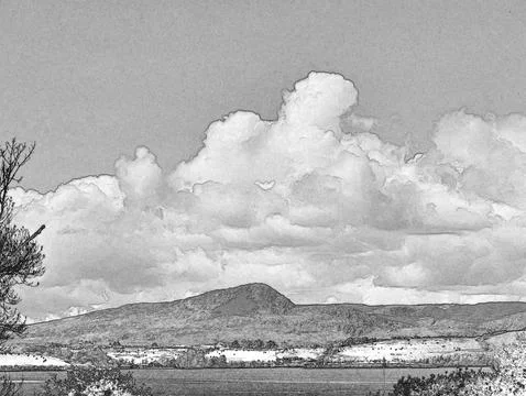 Dramatic storm clouds over rural landscape with hills and field Stock Photos