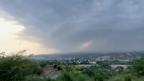 Dramatic Storm Clouds Over Scenic Rural Mountain Village Landscape Scenery Stock Photos