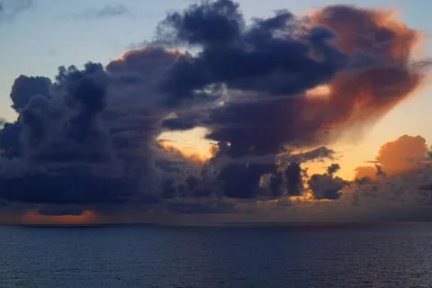 Dramatic Storm Clouds Over the Sea at Sunset Stock Photos