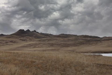 Dramatic storm clouds over steppe hills on Olkhon Island, Lake Baikal 写真素材