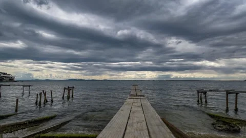 Dramatic storm clouds over wooden pier in fishing village in Nessebar, Burgas 動画素材 346654959
