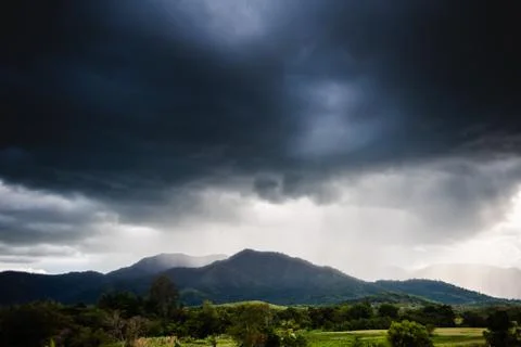 Dramatic storm clouds with rain on mountain 스톡 사진