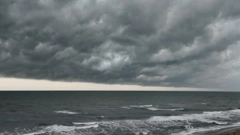 Dramatic storm clouds roll over the sea in atmospheric footage of severe Stock Footage 341481559