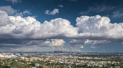 Dramatic storm clouds rolling over city of Los Angeles skyline. 4K UHD timelapse Stock Footage