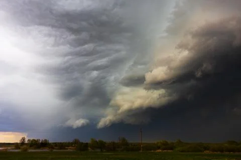 Dramatic storm clouds in the sky, dark severe storm clouds, supercell. Stock Photos