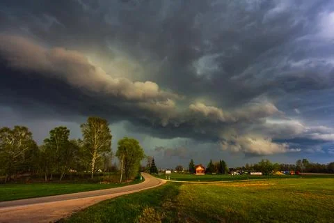 Dramatic storm clouds in the sky, dark severe storm clouds, supercell. Stock Photos