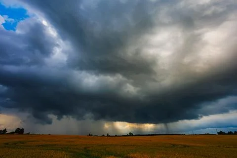 Dramatic storm clouds in the sky, dark severe storm clouds, supercell. Stock Photos