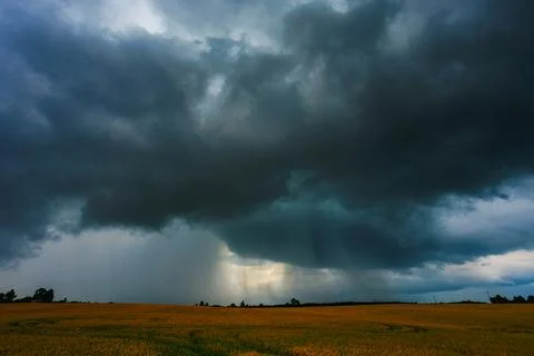 Dramatic storm clouds in the sky, dark severe storm clouds, supercell. Stock Photos
