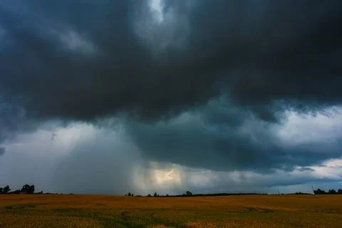 Dramatic storm clouds in the sky, dark severe storm clouds, supercell. Stock Photos