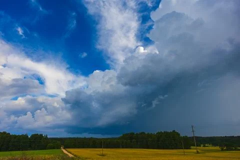 Dramatic storm clouds in the sky, dark severe storm clouds, supercell. Stock Photos