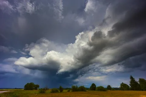 Dramatic storm clouds in the sky, dark severe storm clouds, supercell. Stock Photos