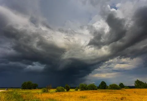 Dramatic storm clouds in the sky, dark severe storm clouds, supercell. Stock Photos