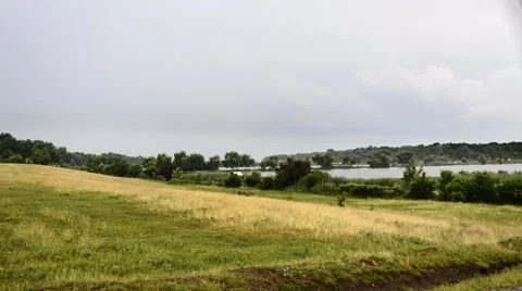 Dramatic storm clouds sky over fishing lake Stock Footage 50754555